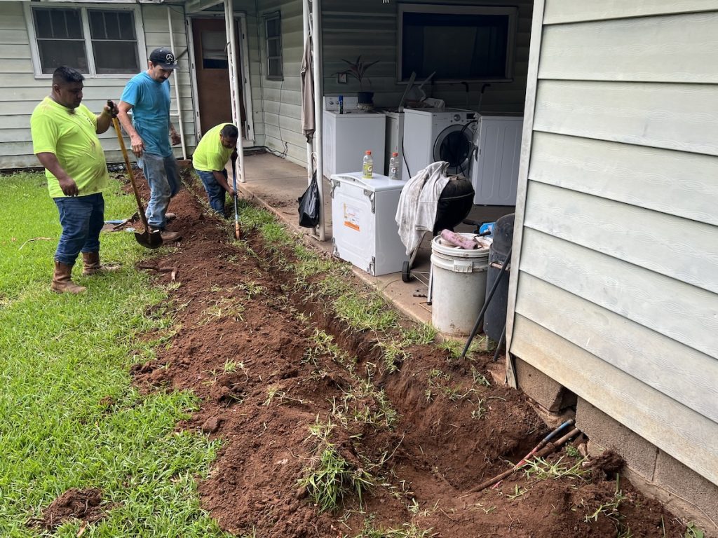 Contractors completing exterior repair work at a home through a CDBG community development project., effective CDBG program