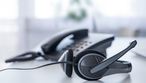 PBCA contact center, communication support, call center and customer service help desk, VOIP headset on laptop computer keyboard