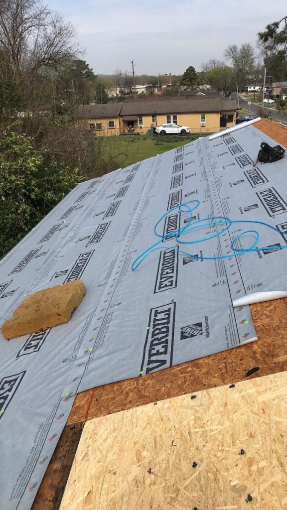 Roof underlayment installation during an emergency housing repair project in Bessemer.