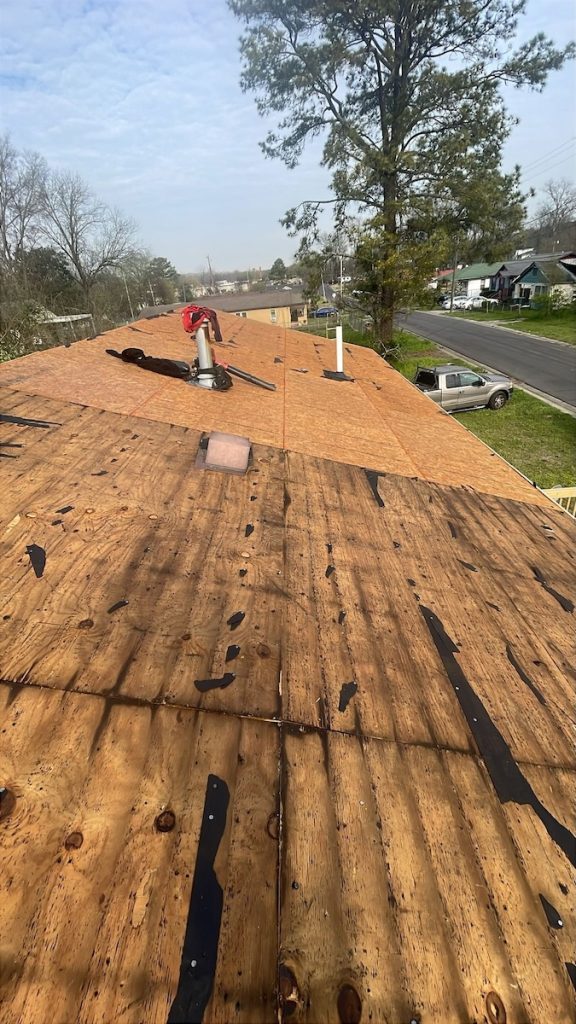 Roof decking repair in progress as part of Bessemer emergency housing repair work.