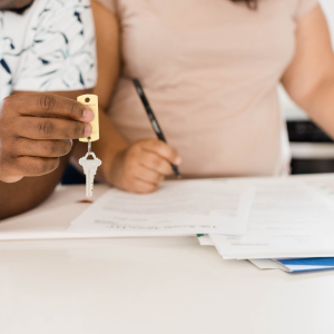 Lease Enforcement. Image features couple receiving keys after signing a lease. 