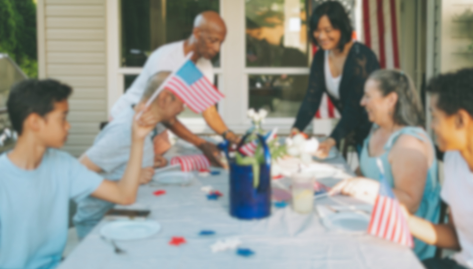 Family enjoys celebratory cookout in image.