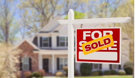 Sold Sign in front of House