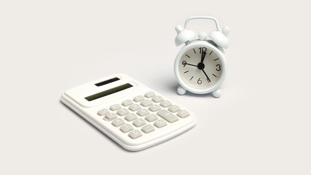 Time Value of Money and Financial Deadline Concept with Calculator and White Clock; 2026 income limits