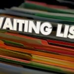Close-up image of colorful file folders in a filing cabinet with the words “WAITING LIST” displayed prominently across the top