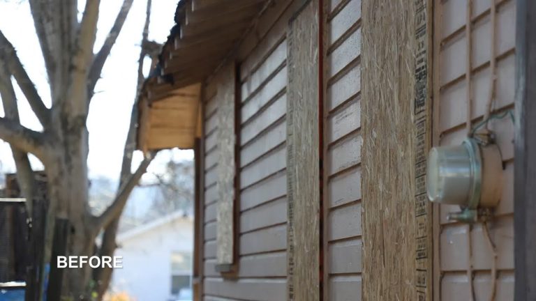 Before image of a home exterior with boarded windows and visible siding.